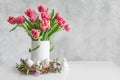 Bouquet of red tulip in vase on white vintage table