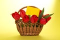 Bouquet Of Red Tulips In Basket And An Empty Card