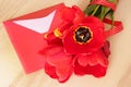 Bouquet of red tulips & envelope on wooden backgound Royalty Free Stock Photo