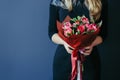 Bouquet of red tulips in girs hands. Unrecognisable.