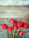 Bouquet of red tulips on light blue wooden retro grunge background with copy space Royalty Free Stock Photo