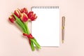 Bouquet of red tulips, notepad on pink background Top view Flat lay Holiday greeting card Happy moter's day, 8 Royalty Free Stock Photo