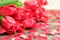 Bouquet of red tulips, silk red hearts on brown wooden planks table close up view selective focus. Spring holidays, Womens, spring