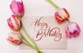 Bouquet of red tulips on white background with text Happy Birthday. Calligraphy lettering Royalty Free Stock Photo