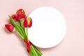 Bouquet of red tulips, white podium on pink background Top view Flat lay Holiday greeting card Happy moter's day Royalty Free Stock Photo