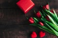 Bouquet of red tulips on a wooden background. Spring flowers. Mother`s Day background Royalty Free Stock Photo