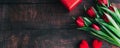 Bouquet of red tulips on a wooden background. Spring flowers. Mother's Day background.Horizontal wide photo subtitle Royalty Free Stock Photo