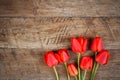 Bouquet of red tulips on wooden retro grunge background with copy space Royalty Free Stock Photo