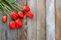 Bouquet of red tulips on wooden retro grunge background with copy space Royalty Free Stock Photo