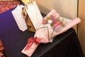 A bouquet of red white flowers and a couple of gift bags wrappings on a table