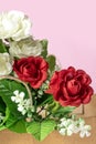 Bouquet of red and white roses in box on pink background Royalty Free Stock Photo