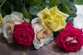 Bouquet of red, yellow and cream roses. On a wooden background, which stand on the windowsill. Window. Summer flowers Royalty Free Stock Photo