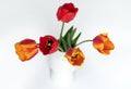 Bouquet of red and yellow tulips in a white vase Royalty Free Stock Photo