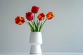 Bouquet of red and yellow tulips in a white vase Royalty Free Stock Photo