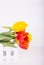 Bouquet of red and yellow tulips on white wooden background Royalty Free Stock Photo