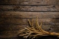 Bouquet ripe wheat ears wooden background