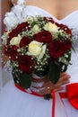 Bouquet of roses in bride hands. Weddind details in closeup view. Solemn event