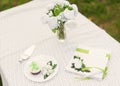 bouquet of roses and cake on plate on the table in the garden