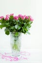 Bouquet of pink roses in a crystal vase on a table Royalty Free Stock Photo