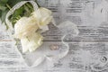 Bouquet of roses decorated with lace on white wooden background Royalty Free Stock Photo