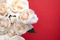 bouquet of roses with dew drops close-up on a red background. Space for text. Natural background for a postcard