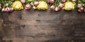 Bouquet of roses of different kinds of flowers, yellow roses and pink shrub roses border ,place text on wooden rustic backgro