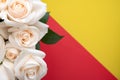 bouquet of roses with drops of dew close-up on a yellow-red background. Space for text. Natural background for a postcard Royalty Free Stock Photo