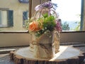 Bouquet of roses in jute cloth on wooden trunk