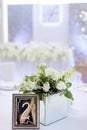 Bouquet of roses near frame with number two on banquet table. Royalty Free Stock Photo