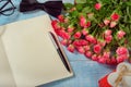 Bouquet of roses with a notebook and a gift Royalty Free Stock Photo