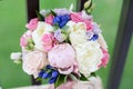 Bouquet of roses and peonies and wedding rings