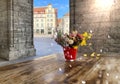 Bouquet of roses red white yellow in red glass cup on wooden table top in street cafe in medieval city ,stone wall of Castle  in T Royalty Free Stock Photo