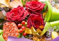 Bouquet of roses and strange flowers. Beautiful bouquet of velvet red roses and different plants.