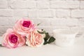 Bouquet of roses on a white desk, A large cup of coffee in front angel, Romantic floral frame background, Floral Styled Wall Mock Royalty Free Stock Photo