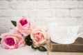 Bouquet of roses on a white desk, A large cup of coffee over old books, Romantic floral frame background, Floral Styled Wall Mock Royalty Free Stock Photo