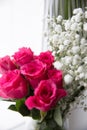 Bouquet of roses and white flowers in a vase on the window Royalty Free Stock Photo