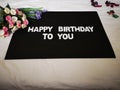 A bouquet of roses wishing a Happy Birthday with black background.