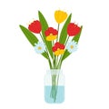 A bouquet of simple flowers of tulips and daisies in a transparent glass jar with water. Bright home decoration. Summer bouquet. Royalty Free Stock Photo