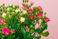 Bouquet of small colored roses on a rose background - Image