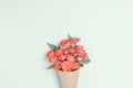 Bouquet of small red roses in vintage paper on the table. Royalty Free Stock Photo