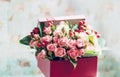 A bouquet of small roses in a box. Vintage gentle style.