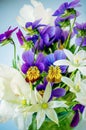 Bouquet of small white wild onion flowers and purple pansies in a vase. Close-up, selective focus Royalty Free Stock Photo