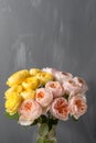 Bouquet of soft pink and yellow garden roses in a glass vase. Floral still life. Royalty Free Stock Photo