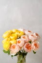 Bouquet of soft pink and yellow garden roses in a glass vase. Floral still life. Royalty Free Stock Photo