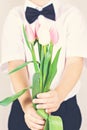 Bouquet of spring flowers in children`s hands.