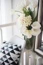 Bouquet of spring flowers in room interior, white tulips and daf Royalty Free Stock Photo