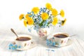 Bouquet of spring flowers. Spring still life of dandelions, forget-me-nots and cups of tea. Isolated on white background