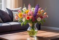 A bouquet of spring flowers in a vase on a table in the living room in the morning sun Royalty Free Stock Photo