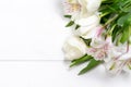 bouquet of spring flowers on a white wooden background with place for text. Royalty Free Stock Photo