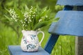 Bouquet of spring lily of the valley flowers on a bench